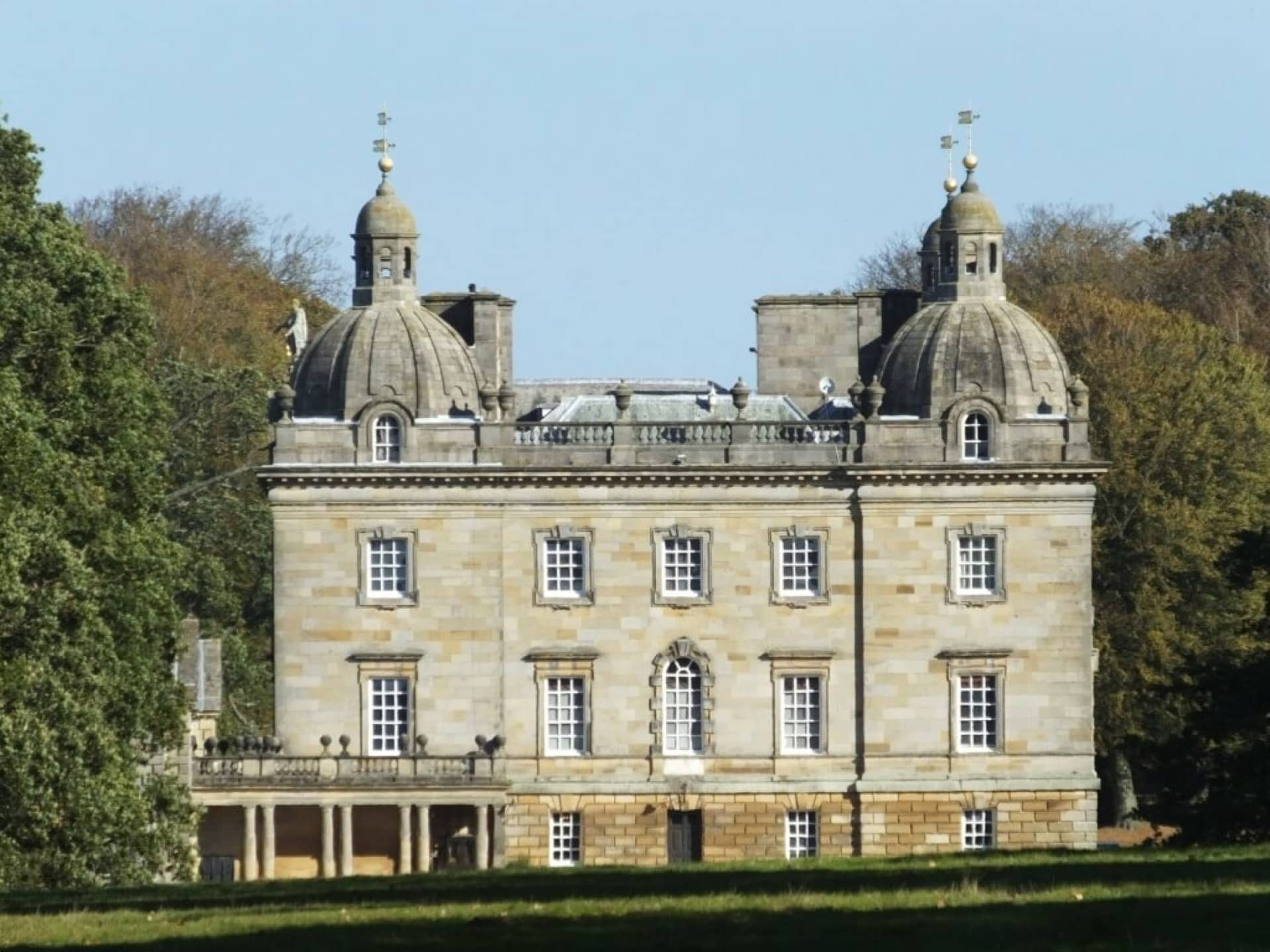 The outside of Houghton Hall stately home on a cloudy day.