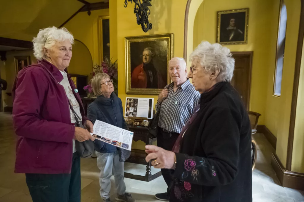 Room guide talking to visitors in the Great Hall at Blicking Estate, Norfolk