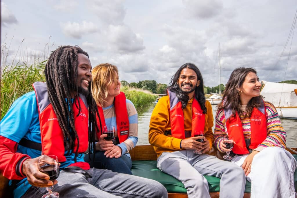 A group of young people drinking wine on a boat