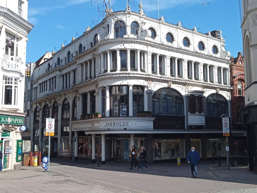 A white shopping centre called Jarrolds pictured on a street corner of Norwich.