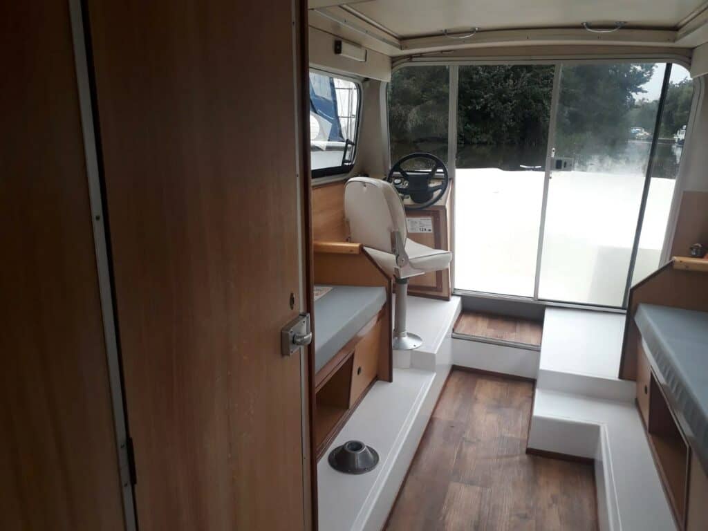 Inside the cabin of a wooden-furnished boat