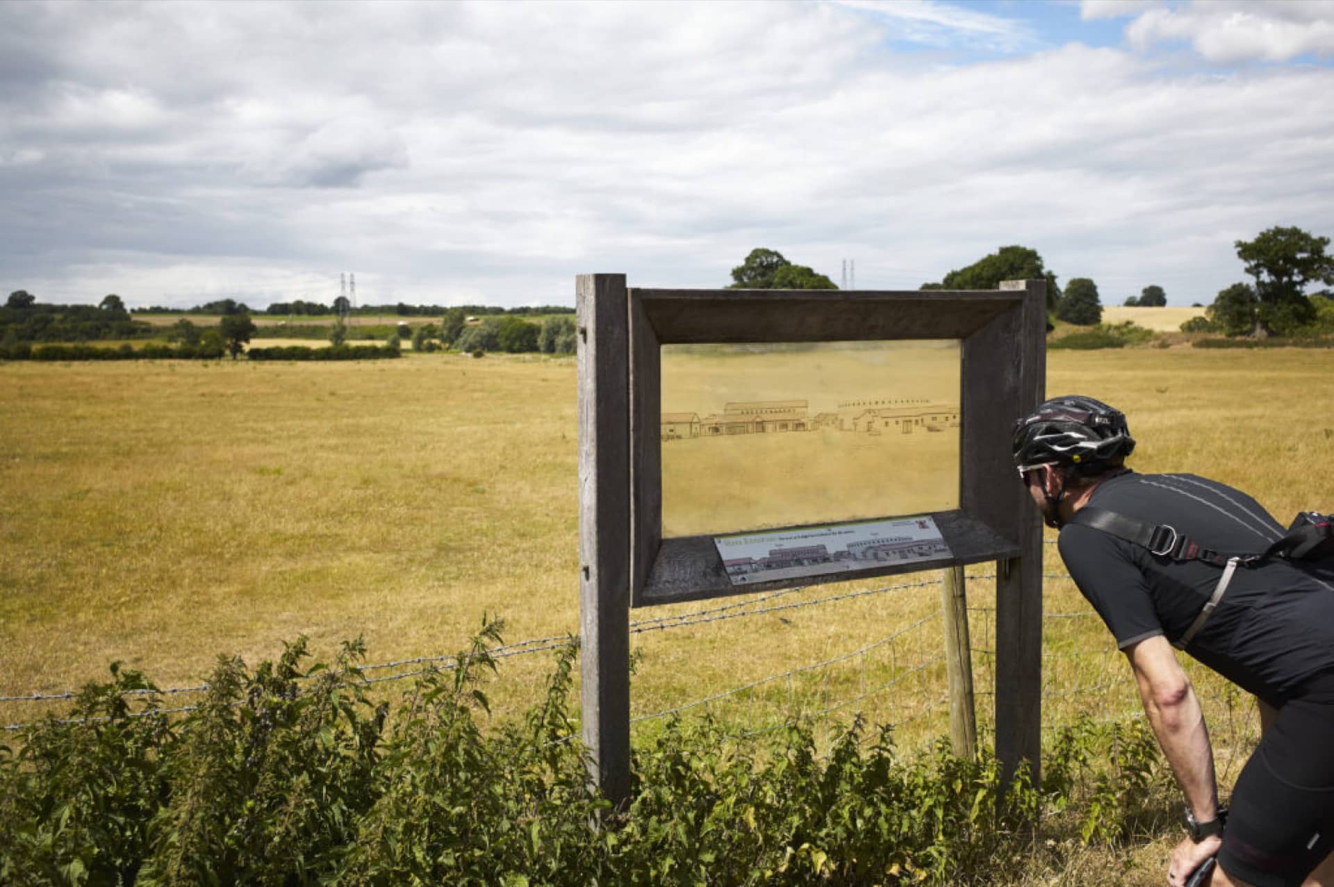 A man looks at an image down a cycle route in Norfolk.