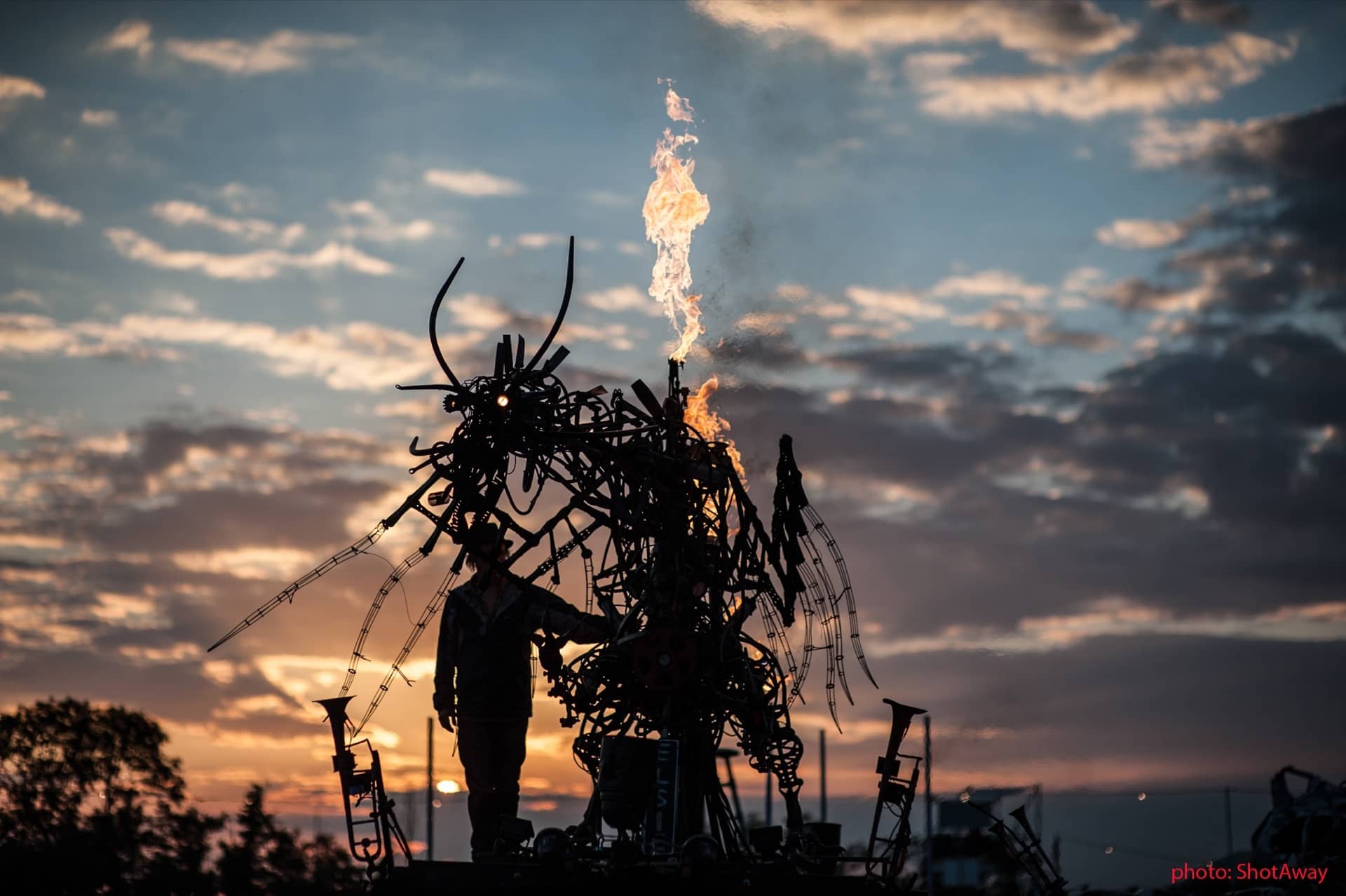 A fire on-top of a sculpture.