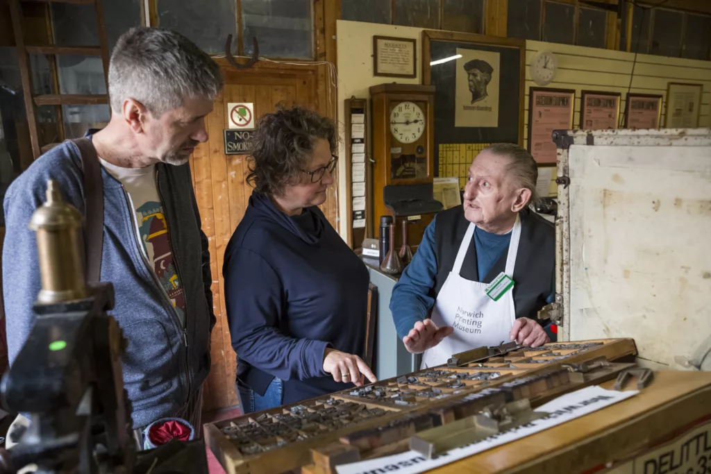 Volunteers demonstrating the traditional skills of the Compositor, Printer and Bookbinder in the working Norwich Printing Museum in the Hall at Blicking Estate, Norfolk