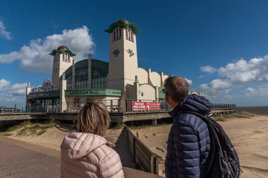 Two people looking at Wellington Pier, Great Yarmouth