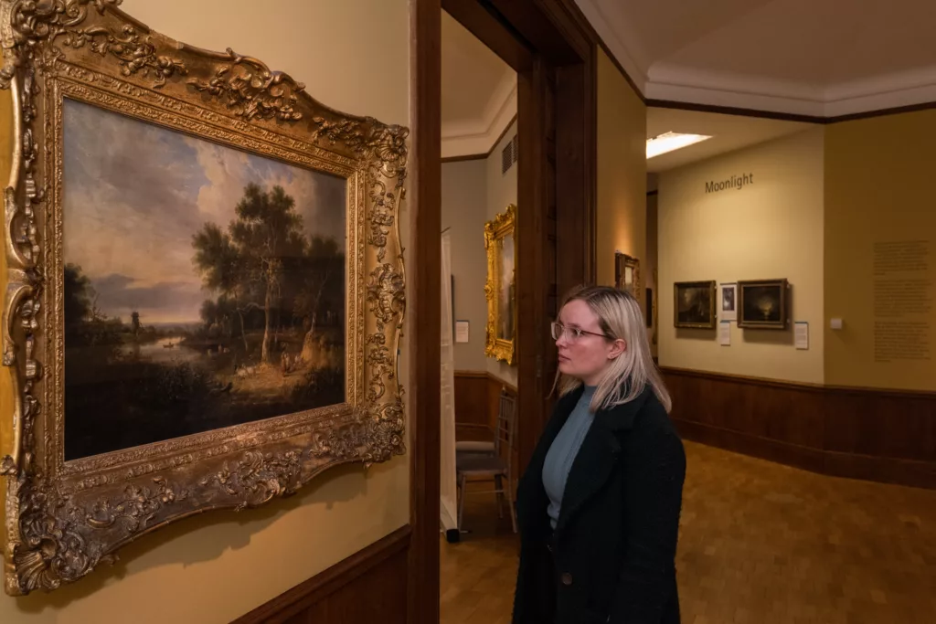 A woman looking at a painting