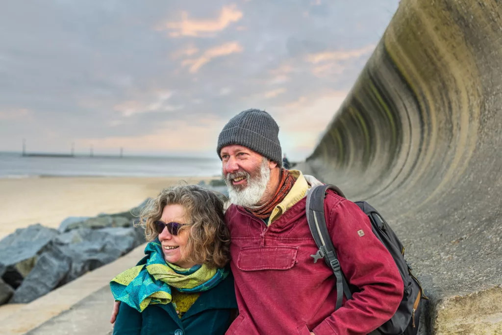 A man and a woman next to the sea wall at Sea Palling