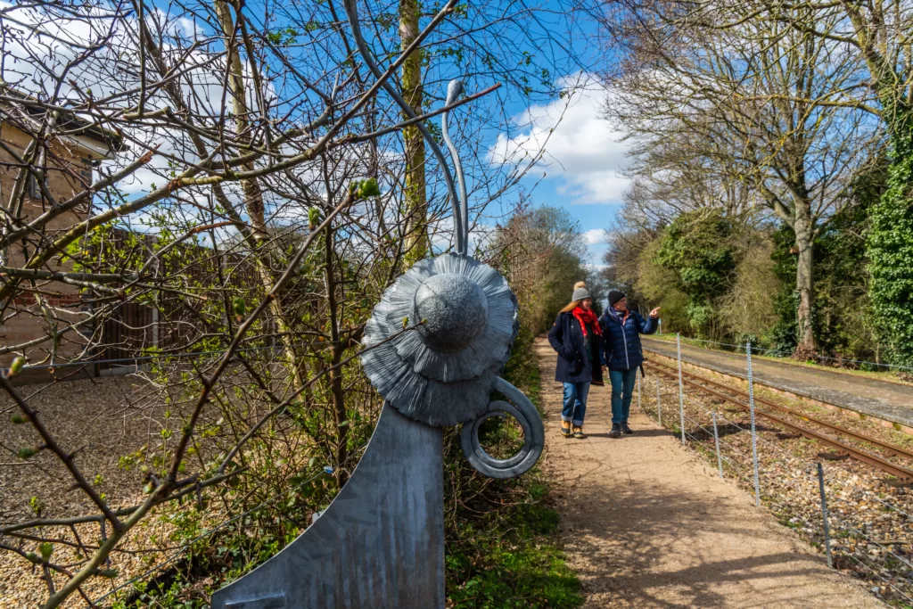 A close up of a carved butterfly head on a waymarker post